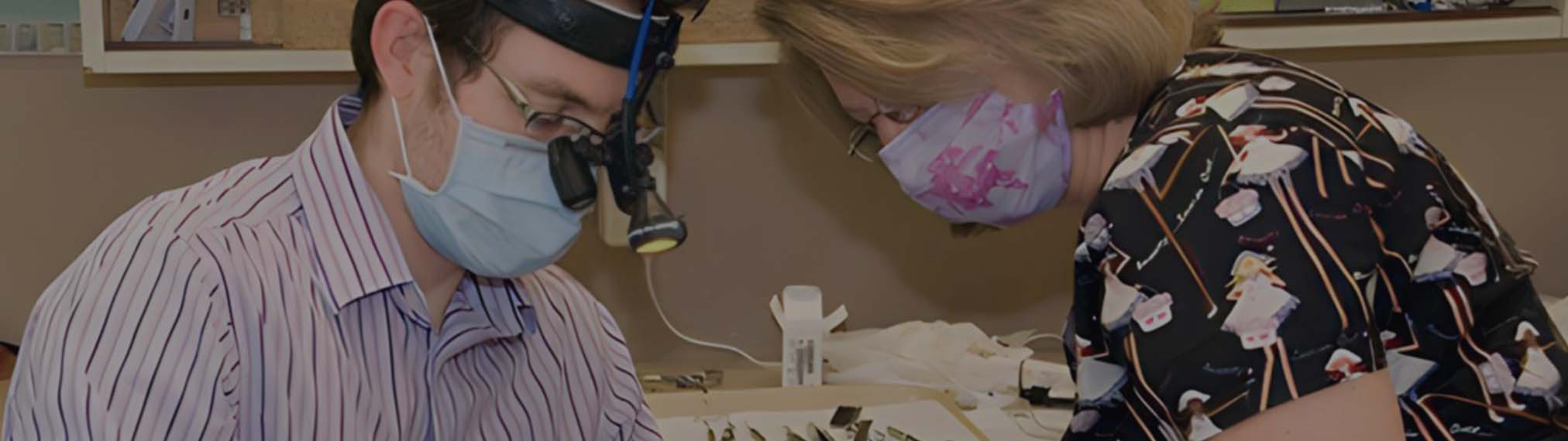 Performing dental exam on patient